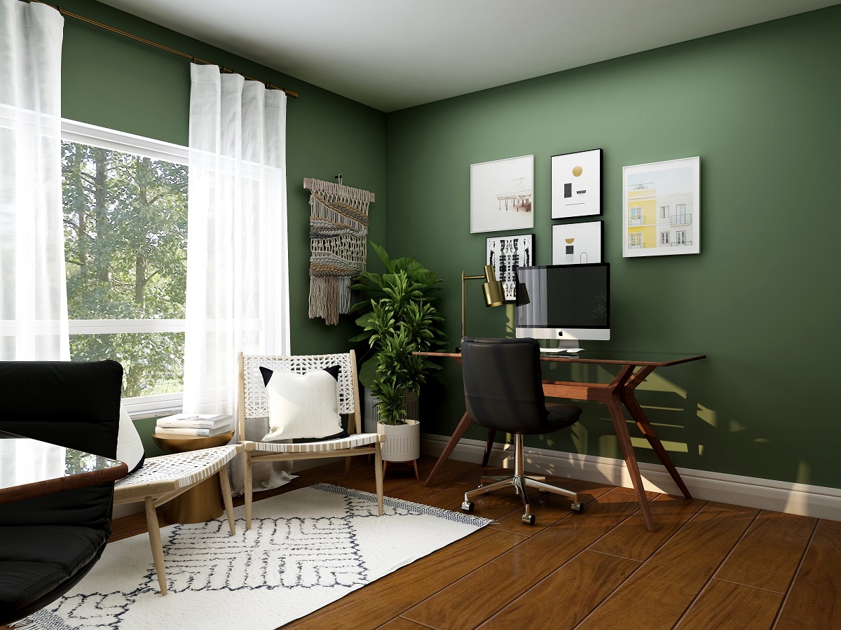 a desk and chair in a green painted room