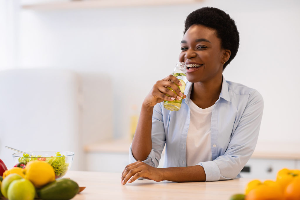 Woman drinking fruit-infused water