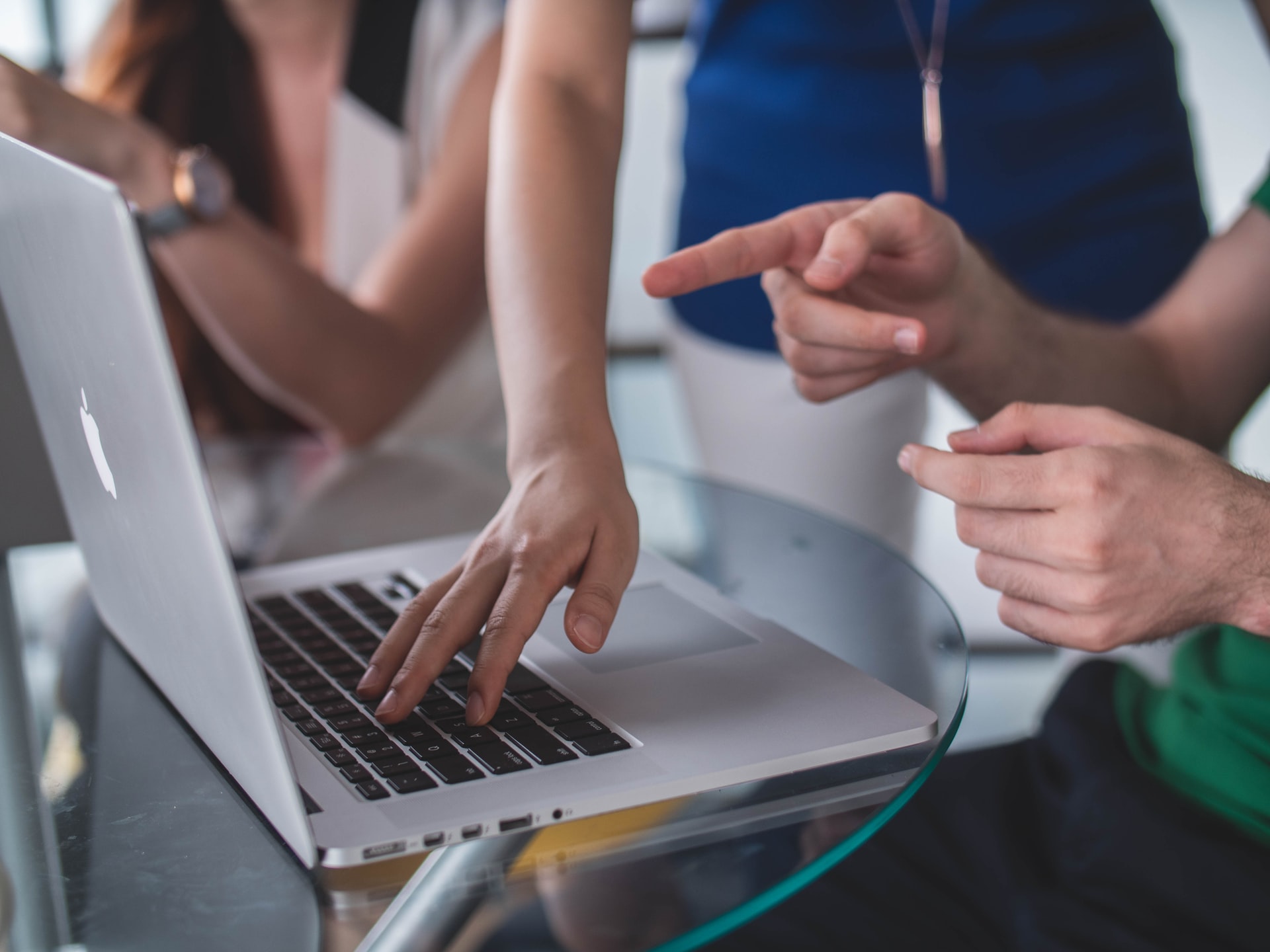 a group of people looking at a laptop