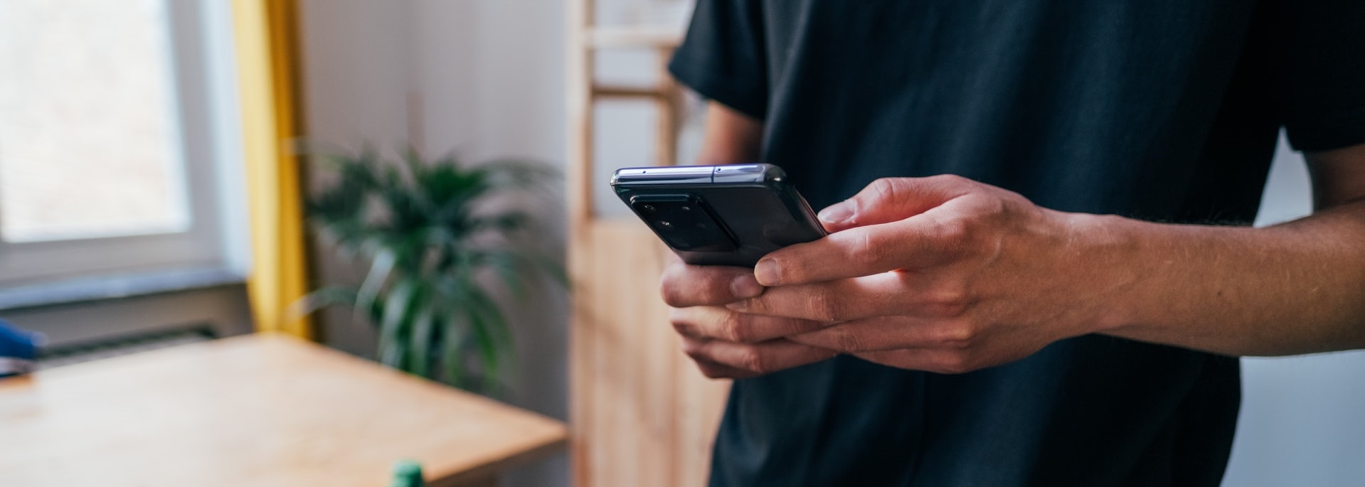 a young man holding a cell phone