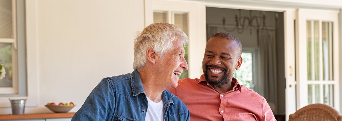 two men talking on a porch