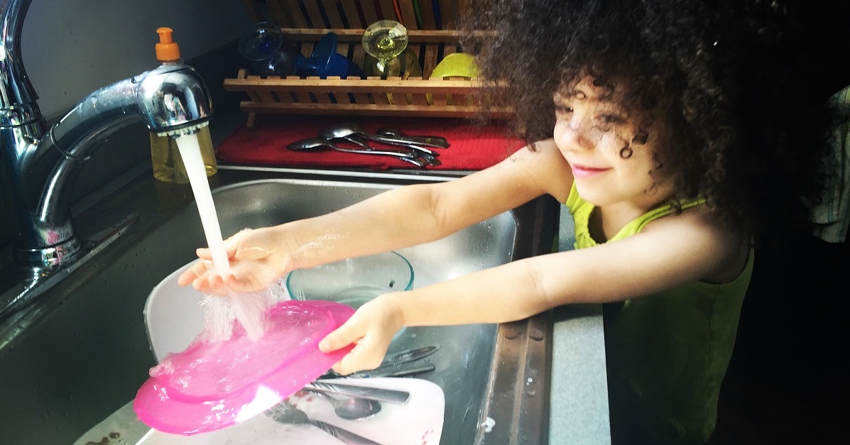 young girl doing dishes