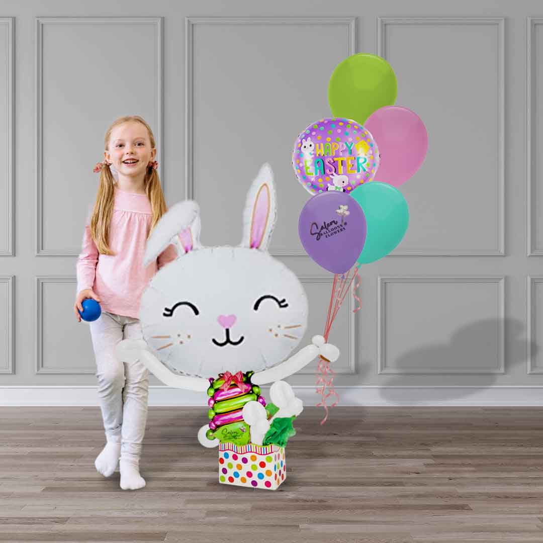 Girl standing next to a Easter Bunny balloon who is holding a helium balloon bouquet.