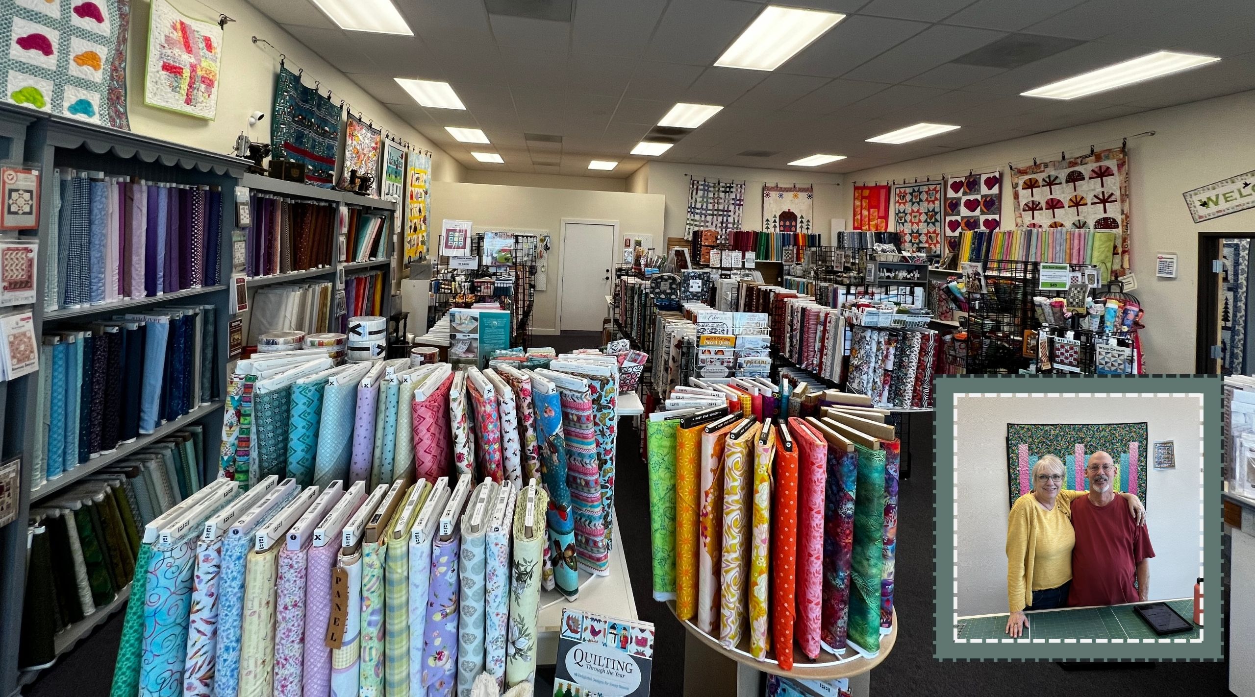 The Cotton Patch view from front of shop / store - fabrics of all kinds colors and patterns along with wall quilt hangings surrounding a neatly appointed space.