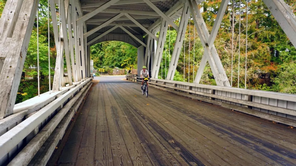 Bicyclist riding on covered bridge